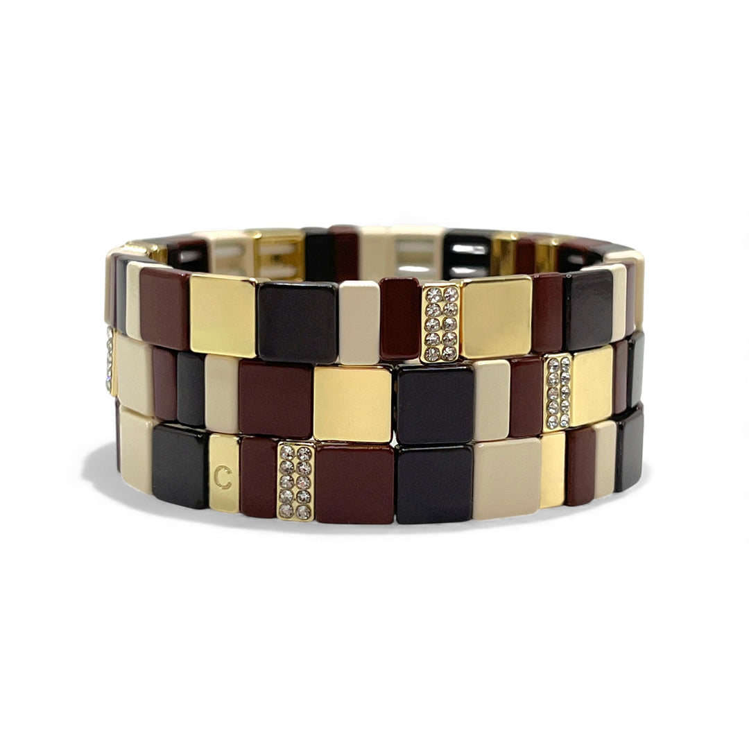 Bordeaux tile bracelet with mini crystals styled in three-stack with cream and gold bracelets. Coralina Jewelry. 