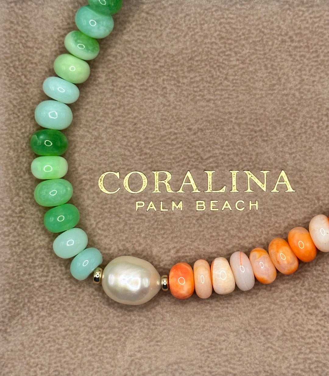 Orange and green opal, pearl necklace finished with a 14K gold filled clasp laid on a custom Italian suede Coralina pouch. 