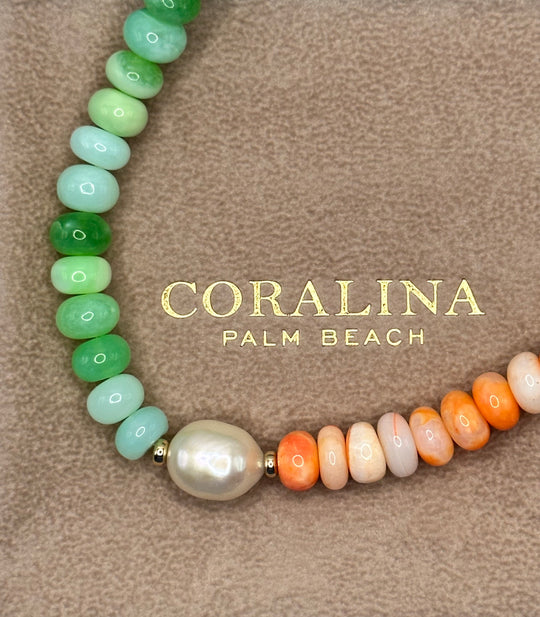 Orange and green opal, pearl necklace finished with a 14K gold filled clasp laid on a custom Italian suede Coralina pouch. 