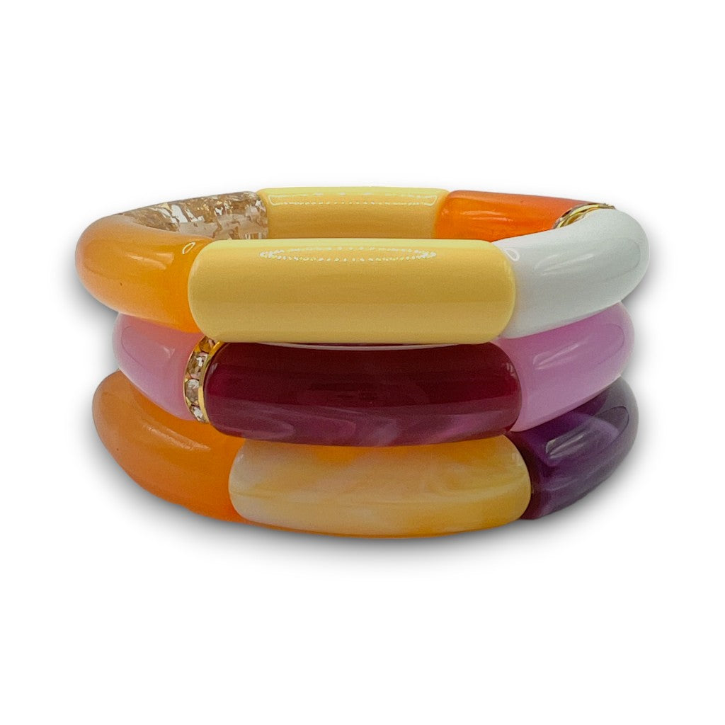 Three yellow, orange and purple beaded resin stretch bracelets with a diamond rhinestone roundel. 