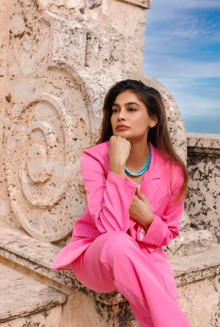 A girl in a pink suit wearing two beaded 8mm Natural Arizona Turquoise and 14K Gold Necklaces. 