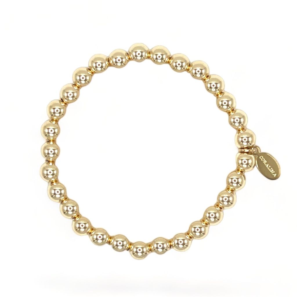 14K Gold Bead Bracelet (6mm) with a custom Coralina tag. 
