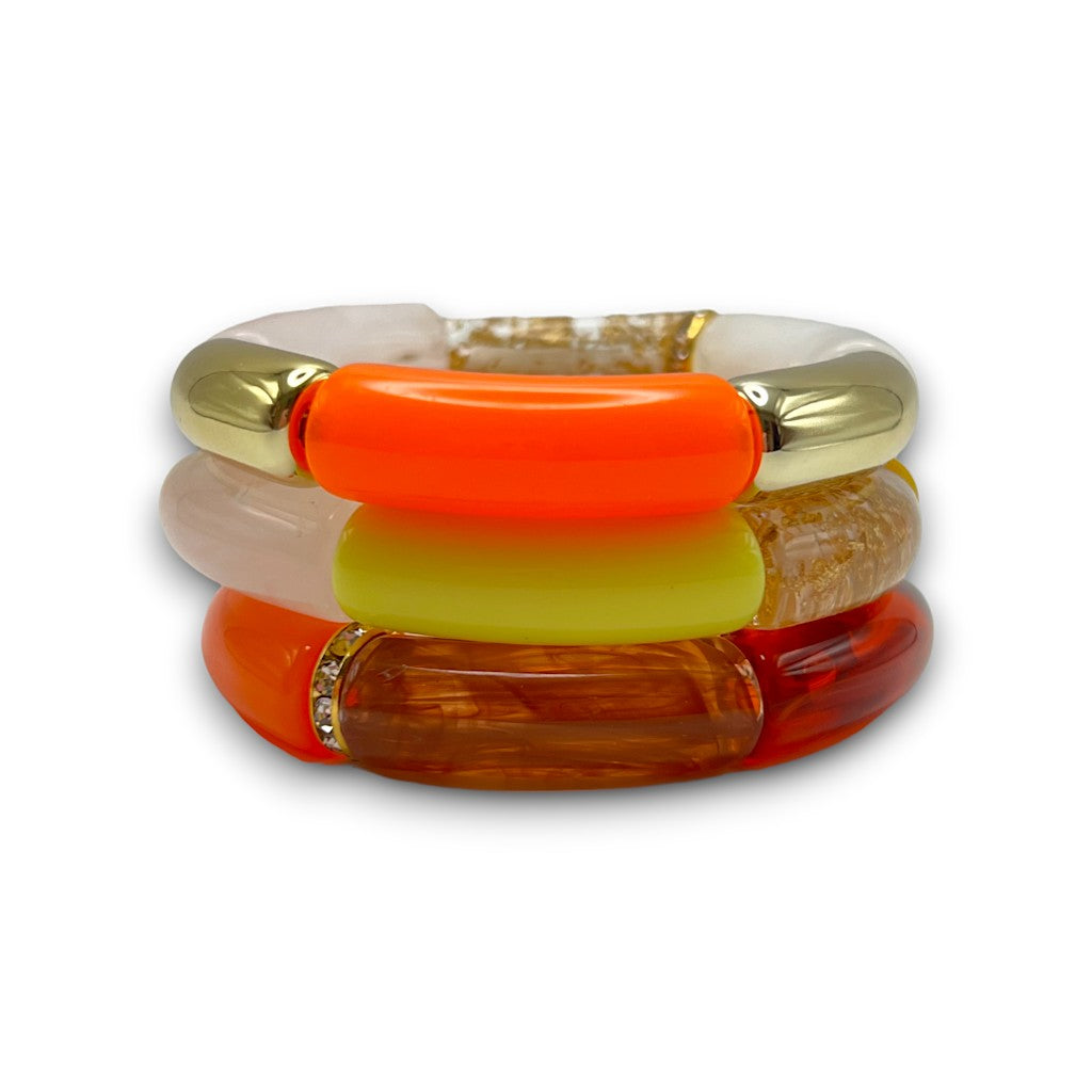 Three Gold, orange, and white beaded resin stretch bracelets with a diamond rhinestone roundel. 