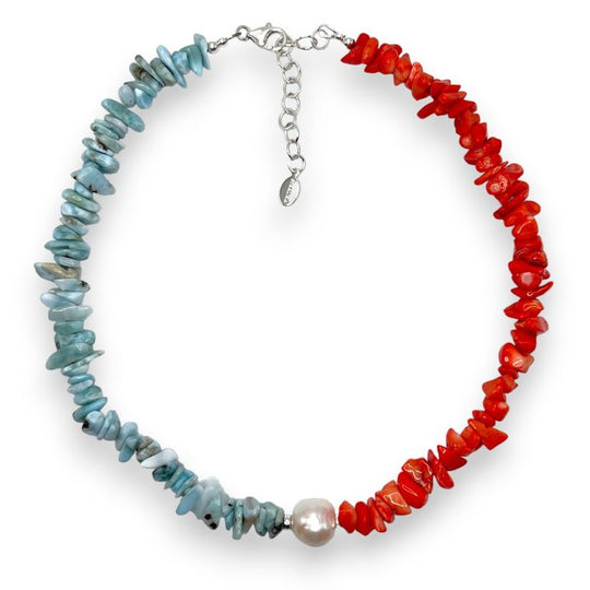 Red Mediterranean coral and blue larimar necklace offset by a large white baroque pearl and finished with 925 sterling silver. 