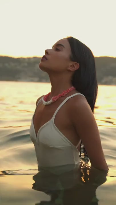 Model wearing the Verona Pink and White Coral Necklace as the evening light hits it. Palm beach jewelry. 